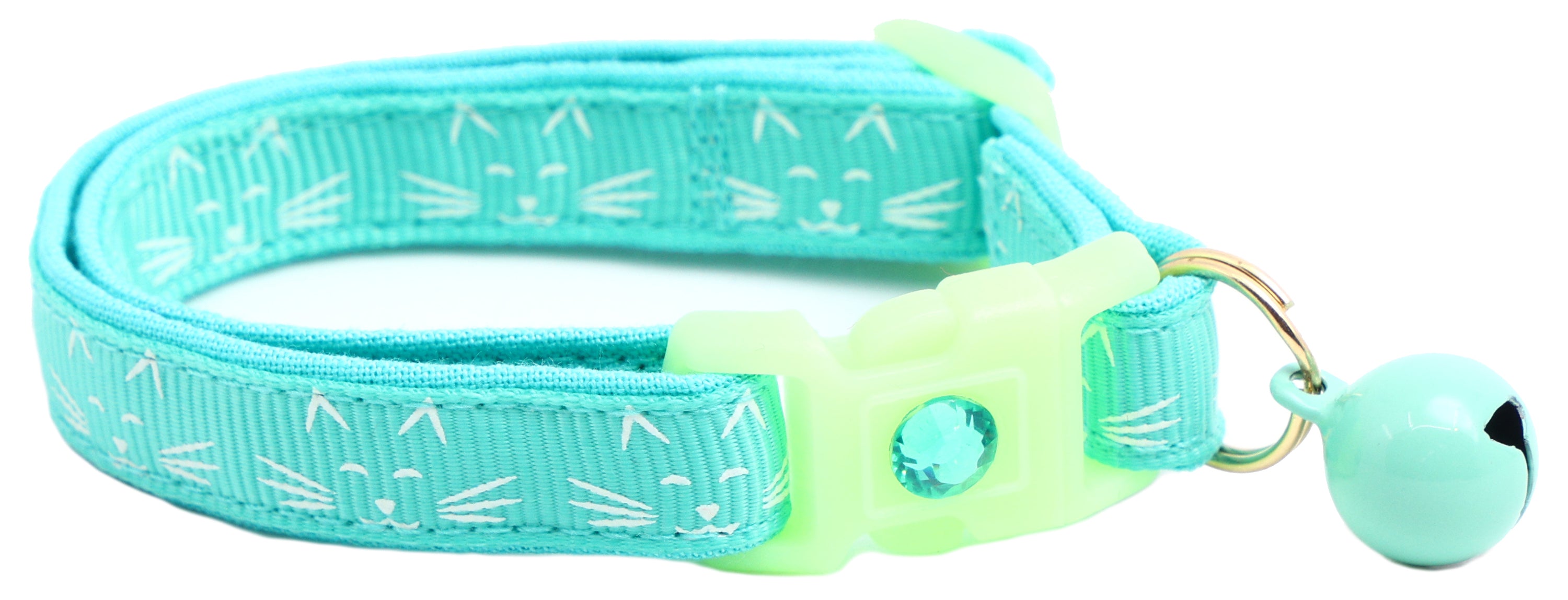 A glowing cat faces breakaway collar made of reinforced cotton, featuring a bell and charm, perfect for nighttime visibility.